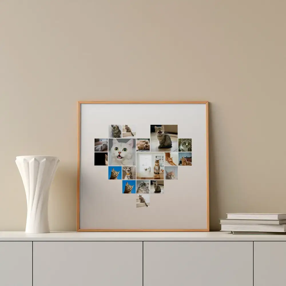 Heart-shaped cat photo collage in a natural wood frame on a sideboard beside a white vase and books