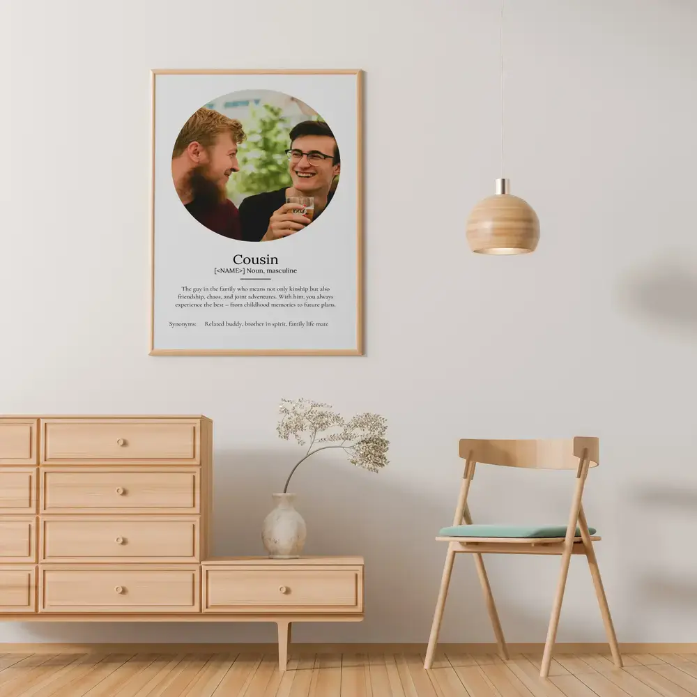 Cousin definition poster with a round photo in a light wood frame on the wall above a wooden dresser