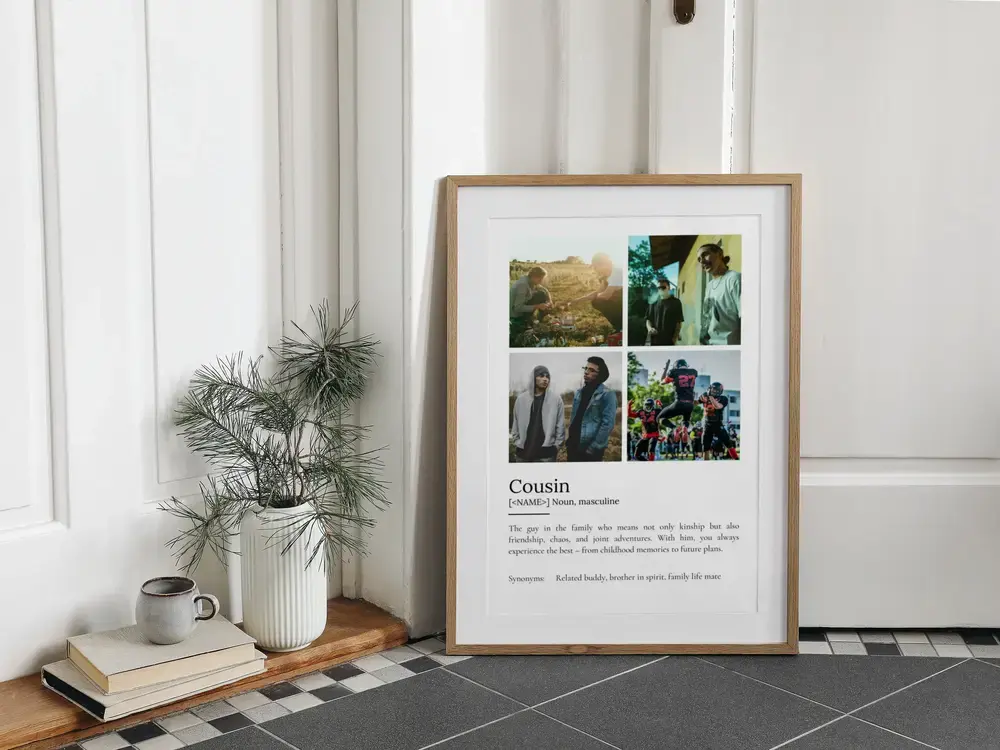 Cousin definition poster with four photos in a wood frame, leaning against a paneled wall beside books and a vase