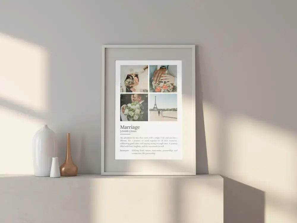 Marriage definition poster with a four-photo wedding collage in a white frame on a sunlit cabinet beside vases