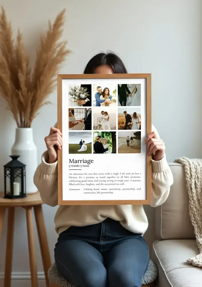 Wood-framed marriage definition poster with nine wedding photos, displayed beside a sofa and pampas grass