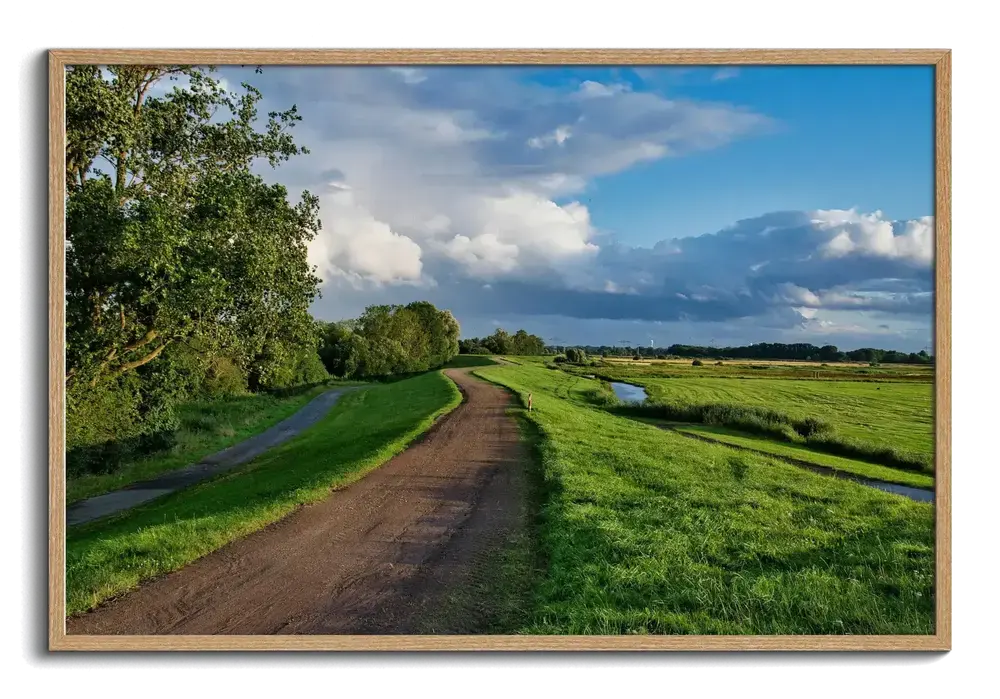 Acrylic landscape photo print with a country path and green meadows in a natural wood frame