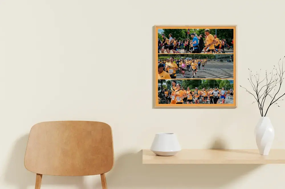 Corporate run photo collage with three photo strips and an orange border on a light wall beside a wooden chair