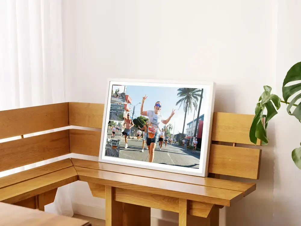 White-framed marathon photo collage with a large running photo on a wooden bench, a gift to celebrate finishing