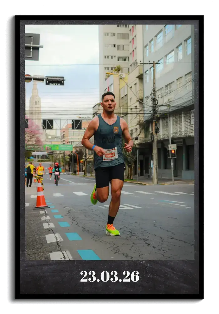 Marathon photo print in a black frame, showing a runner on a city course with a date on the dark lower border