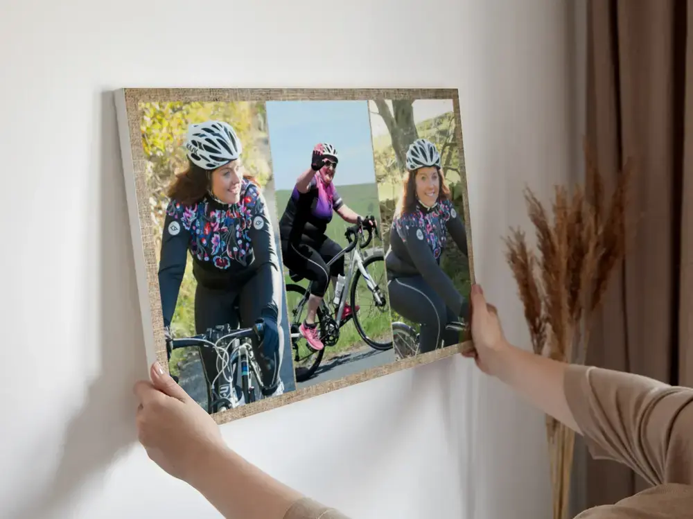 Three-photo cycling collage in a wood frame against a light wall, a birthday gift for a cyclist