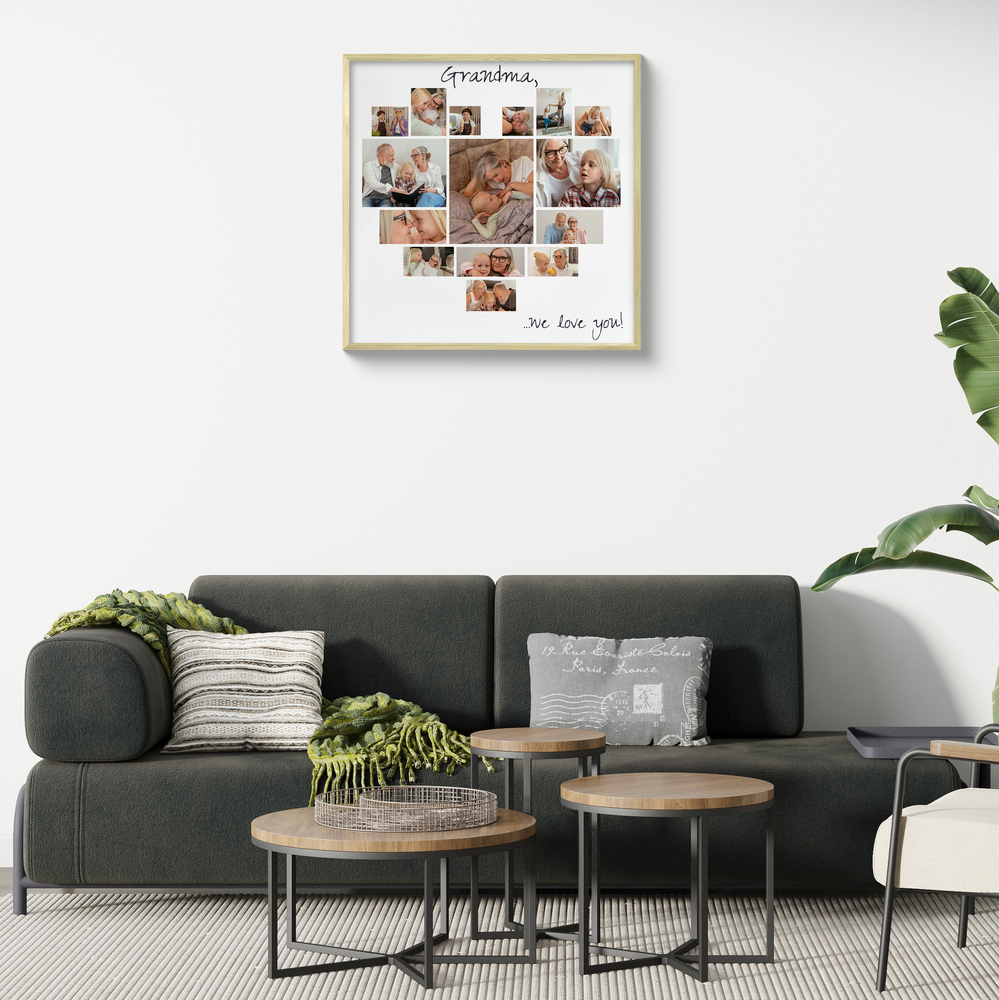 Heart-shaped photo collage in a light wood frame above a dark sofa, a thoughtful gift for Grandma
