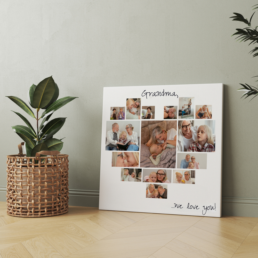 Heart-shaped photo collage on canvas with a large center photo, leaning against a wall beside a potted plant