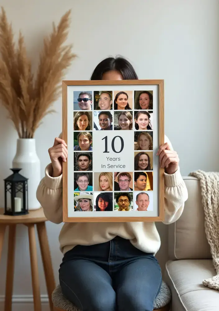 Photo collage with coworker portraits surrounding a large 10, in a natural wood frame in a living room