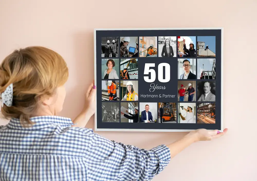 Framed photo collage on a pale wall with a large 50, custom company name, and team photos for a business anniversary