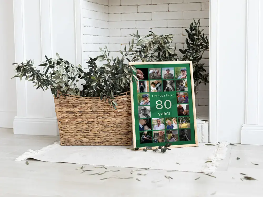 Green 80th birthday photo collage in a wood frame, resting on the floor beside a woven plant basket and white brick wall