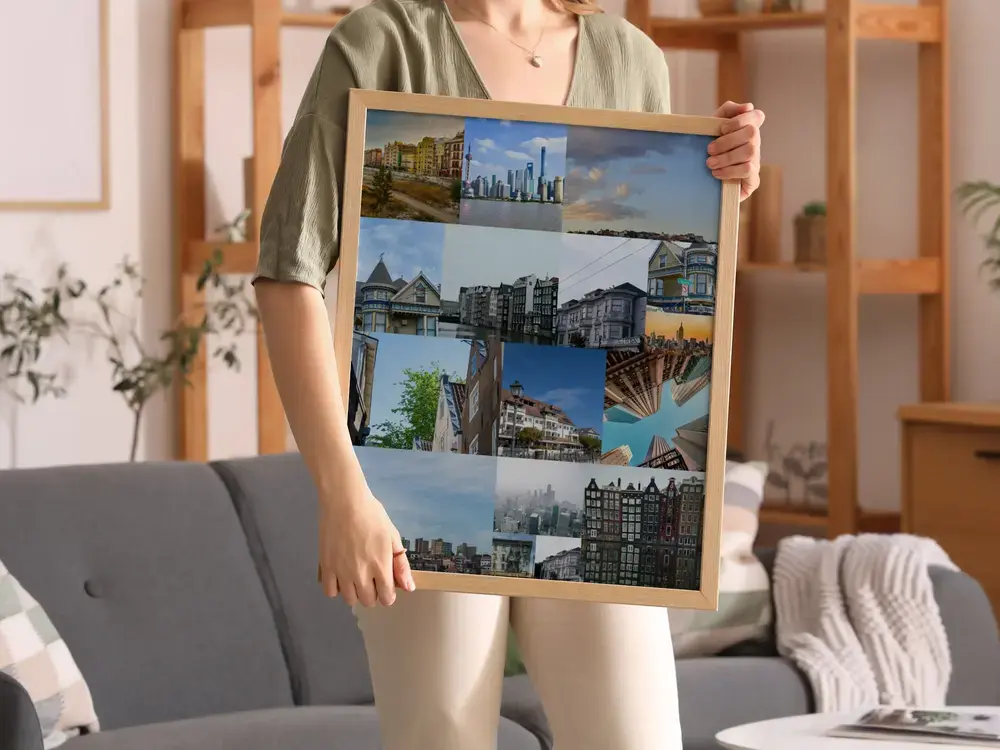 City travel photo collage in a light wood frame in front of a gray sofa, a gift idea for travel lovers