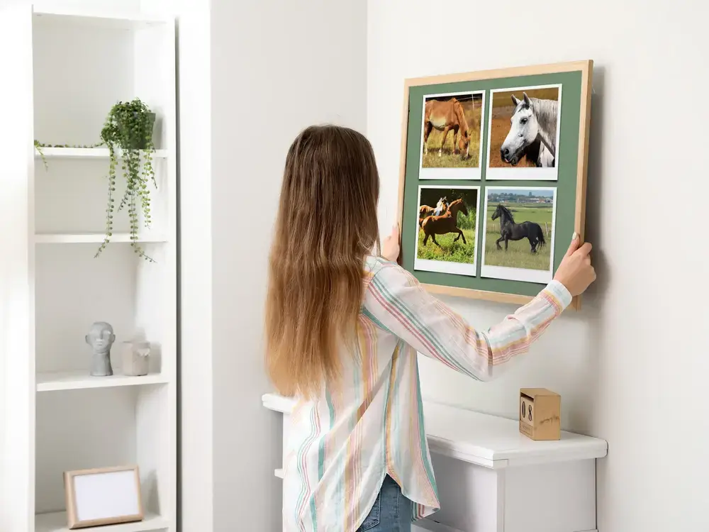 Polaroid-style horse photo collage in a natural wood frame above the mantel in a bright living room