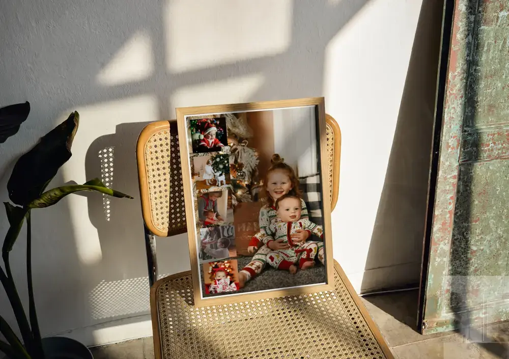 Christmas photo collage with a large photo of children and a side photo strip, in a wood frame on a woven chair